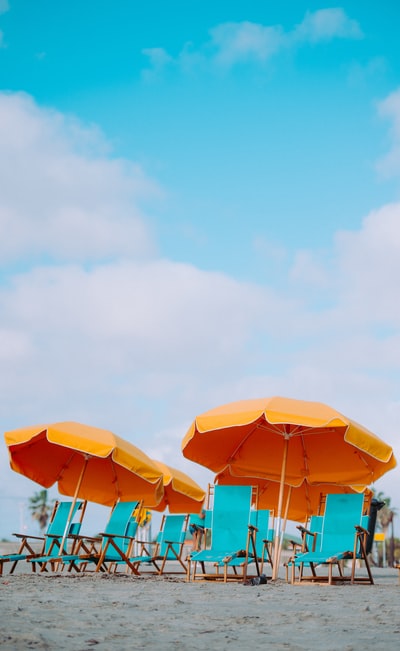 Close-up of deck chair and beach umbrella
